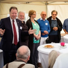 Der Rektor der Universität Stuttgart begrüßt mit anderen Kolleg*innen die Alumnae und Alumni im Uni-Pavillon.